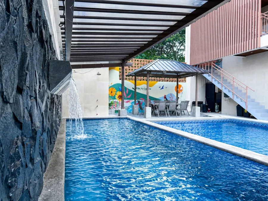 The swimming pool at Bel Air Laguna Private Hot Spring Resort, with a covered dining area and a mural.